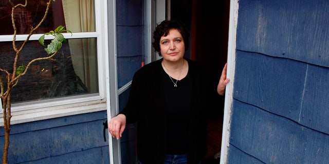 gardening In this April 29 photo, Julie Hitchcock stands in her back doorway in Milwaukee.