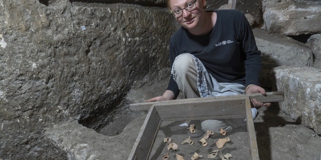 Tehila Sadiel holding the finds. (Shai Halevi-Israel Antiquities Authority)