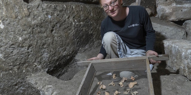 Tehila Sadiel holding the finds. (Shai Halevi-Israel Antiquities Authority)