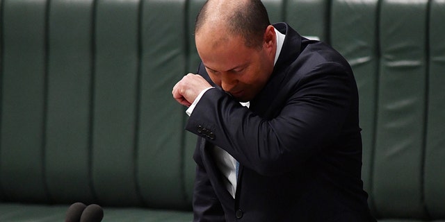 Australia's treasurer tested for COVID-19 after coughing in parliament