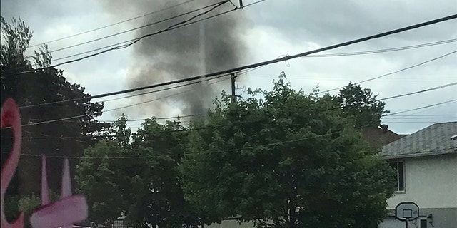A plume of smoke rising over houses in Kamloops following the plane crash.