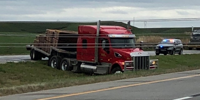 A semi-truck nearly hit power lines that were knocked down by a severe thunderstorm in Kansas on Monday.