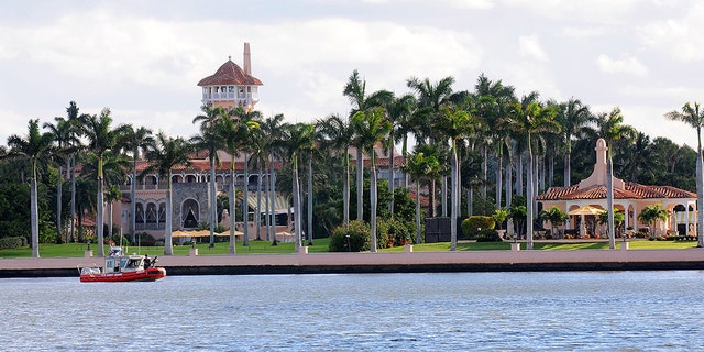 A U.S. Coast Guard boat passes through the Mar-a-Lago Resort (Photo by Gerardo Mora/Getty Images)