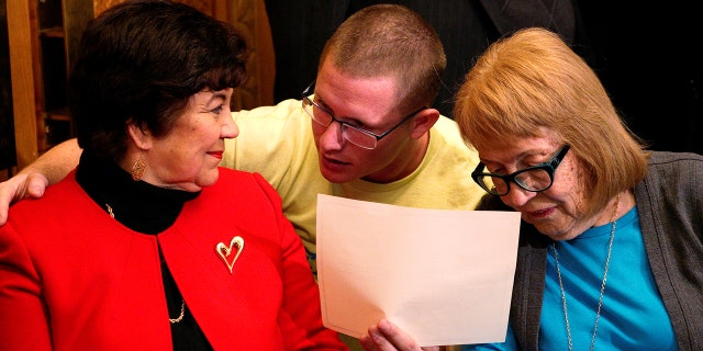 Electoral College electors (L-R) Sen. Polly Baca, Michael Baca and Ann Knollman talk before taking the oath of office in the Governor's office at the State Capitol in Denver, U.S. December 19, 2016. REUTERS/Rick Wilking