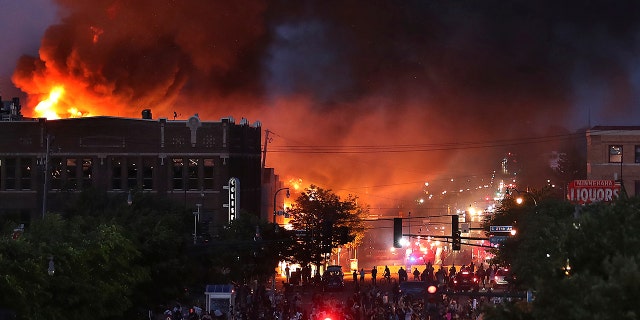 Seen from Hiawatha Avenue, a large fire burns Thursday, May 28, 2020. (David Joles/Star Tribune via AP)