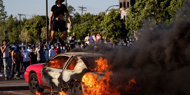 A car burns in a Target parking lot Thursday, May 28, 2020, in Minneapolis. (Carlos Gonzalez/Star Tribune via AP)