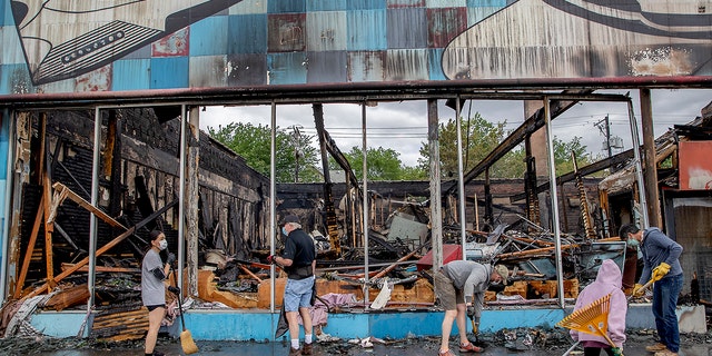 Hundreds of volunteers showed up to clean along University Avenue on Friday, May 29, 2020, in St. Paul, Minn. (Elizabeth Flores/Star Tribune via AP)