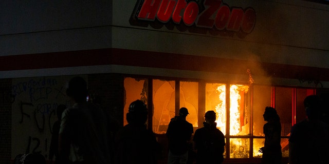 A fire burns in an AutoZone store during a protest Wednesday, May 27, 2020, in Minneapolis against the death of George Floyd in Minneapolis police custody earlier in the week. (Christine T. Nguyen/Minnesota Public Radio via AP)