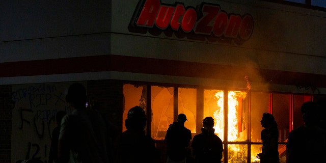A fire burns in an AutoZone store during a protest Wednesday, May 27, 2020, in Minneapolis against the death of George Floyd in Minneapolis police custody earlier in the week. (Christine T. Nguyen/Minnesota Public Radio via AP)