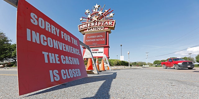 Traffic passes the closed Ameristar Casino in Vicksburg, Miss., Tuesday, March 17, 2020. All of Mississippi's state-regulated casinos were ordered closed by midnight Monday to limit the spread of the new coronavirus. (AP Photo/Rogelio V. Solis)