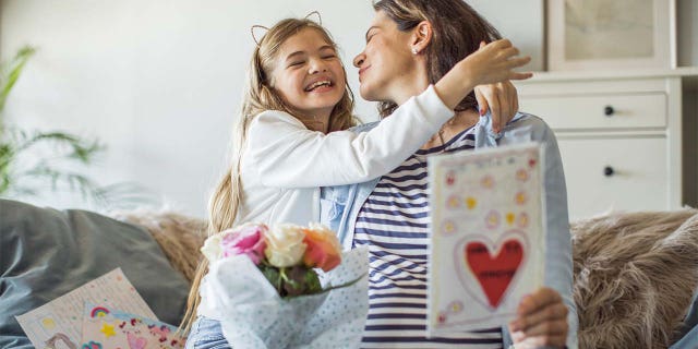A daughter is shown surprising her mom on Mother's Day — which is coming up fast on May 8 this year.