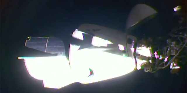 In this image taken from NASA TV video, the SpaceX Dragon crew capsule, with NASA astronauts Doug Hurley and Robert Behnken aboard, docks with the International Space Station Sunday, May 31, 2020.