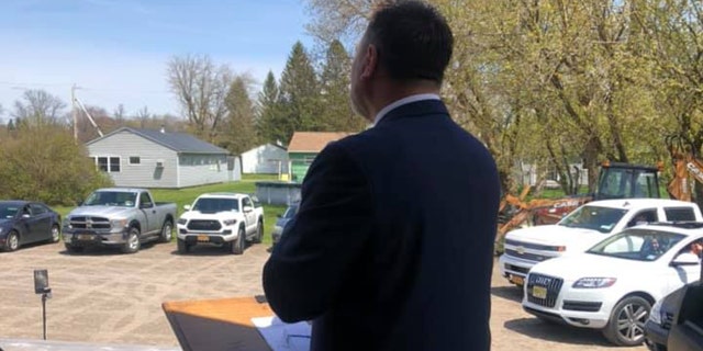 Pastor Samson Ryman preaches during a drive-in service Sunday, May 17, 2020.