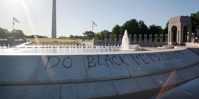 Spray paint that reads "Do Black Vets Count?" is seen World War II Memorial on the National Mall in Washington, Sunday, May 31, 2020, the morning after protests over the death of George Floyd. Floyd died after being restrained by Minneapolis police officers on Memorial Day.