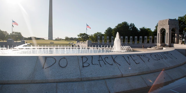 Spray paint that reads "Do Black Vets Count?" is seen World War II Memorial on the National Mall in Washington, Sunday, May 31, 2020, the morning after protests over the death of George Floyd. Floyd died after being restrained by Minneapolis police officers on Memorial Day.