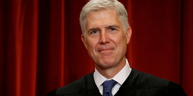 U.S. Supreme Court Justice Neil Gorsuch participates in taking a new "family" photo with his fellow justices at the Supreme Court building in Washington, D.C., U.S., June 1, 2017.