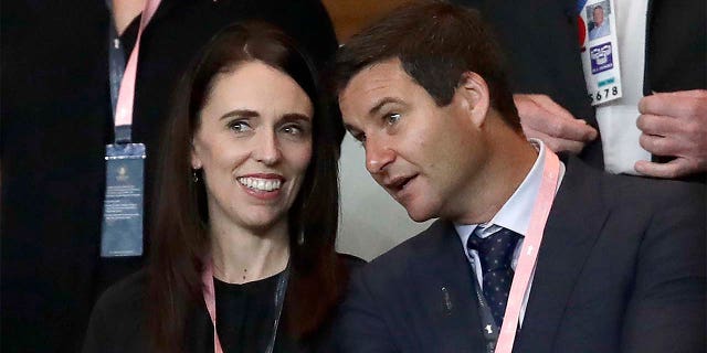In this Sept. 21, 2019, file photo, New Zealand Prime Minister Jacinda Ardern, left, stands with her fiance Clarke Gayford as they watch rugby in Yokohama, Japan.