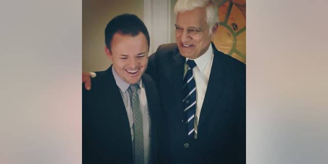 Christian leaders Nick Hall and Ravi Zacharias laugh together.