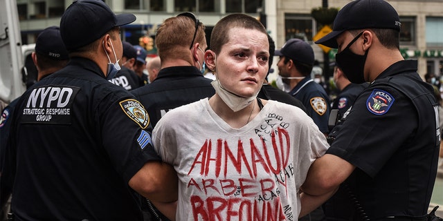 NEW YORK, NY - MAY 28: A protesters is detained by police during a rally against the death of Minneapolis, Minnesota man George Floyd at the hands of police on May 28, 2020 in Union Square in New York City. Floyd's death was captured in video that went viral of the incident. Minnesota Gov. Tim Walz called in the National Guard today as looting broke out in St. Paul. (Photo by Stephanie Keith/Getty Images)