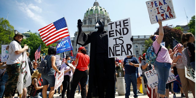 Protesters demonstrate during a rally against Pennsylvania's coronavirus stay-at-home order at the state Capitol in Harrisburg, Pa., Friday, May 15, 2020. (AP Photo/Matt Rourke)