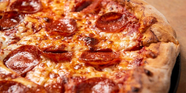 A man attempted to rob a pizza shop in Delaware with a machete on Friday, only to have the owner throw a pizza at him, according to state police.