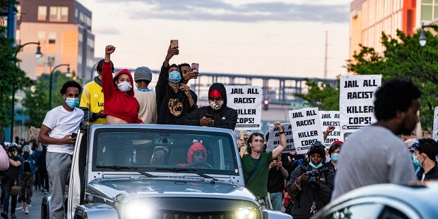 Protesters skirmish with the National Guard near the 3rd Precinct before heading down Lake St. towards the 5th Precinct in Minneapolis, Minn., Friday, May 29, 2020.