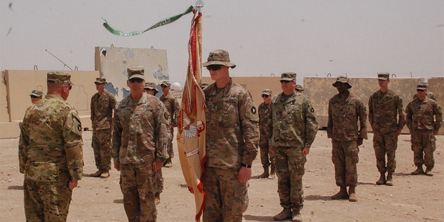 Members of the Headquarters Support Company, 834th Aviation Support Battalion stand in formation (maintaining physical distancing standards for COVID-19 prevention) on May 2, 2020, at Camp Buehring, Kuwait, during the Purple Heart presentation ceremony for Maj. Alan Johnson. (U.S. Army photo by Sgt. Morgan Maidl)