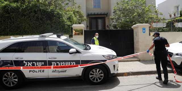 An Israeli policeman cordons off an area near the house of China's ambassador to Israel, Du Wei, in Herzliya, north of Tel Aviv, on Sunday. REUTERS/Nir Elias - RC28QG94RYQO