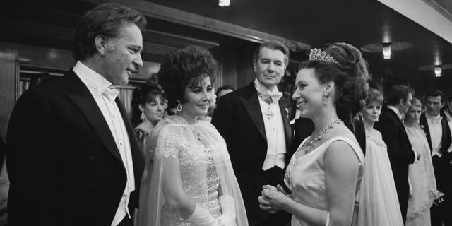 Princess Margaret (1930 - 2002, right) chatting with Richard Burton (1925 - 1984) and his wife Elizabeth Taylor (1932 - 2011). 