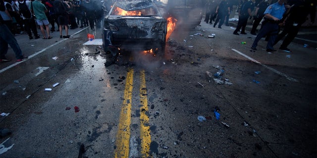 An Atlanta Police Department vehicle burns during a demonstration against police violence, Friday, May 29, 2020 in Atlanta. The protest started peacefully earlier in the day before demonstrators clashed with police. (AP Photo/Mike Stewart)