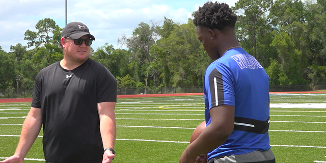Kolby Tackett (left), Head Football Coach at Mount Dora Christian Academy, speaks with his quarterback, Tyquan Wiggins (Robert Sherman, Fox News)