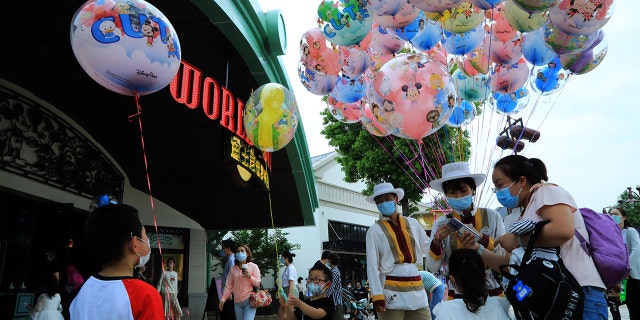 Visitors are seen on May 1 at Shanghai Disney Resort's Disneytown shopping and dining district, which previously opened to guests in March.
