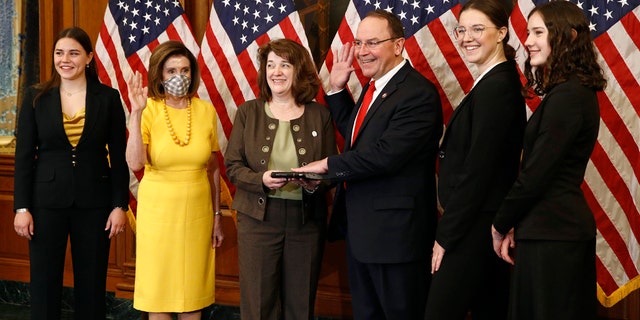 Pelosi swears in two new GOP members of Congress 4 House Speaker Nancy Pelosi of Calif., second from left, wears a face mask to protect against the spread of the new coronavirus as she conducts a ceremonial swearing-in for Rep. Tom Tiffany, R-Wis., third from right, joined by his wife Chris, center, and daughters Lexie, from left, Karlyn and Katherine on Capitol Hill in Washington, Tuesday, May 19, 2020. (AP Photo/Patrick Semansky)
