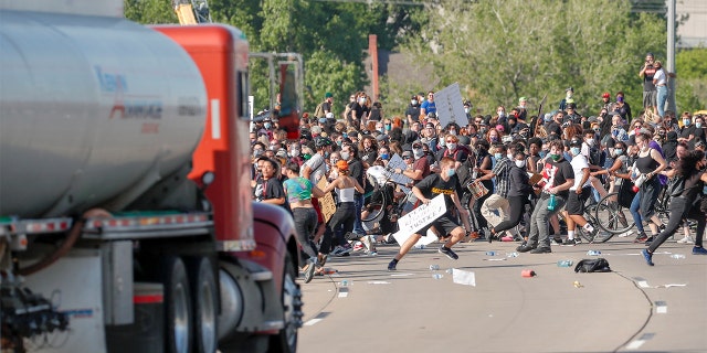 A tanker truck speeding toward protesters marching on the highway during a protest against George Floyd's death in Minneapolis police custody.