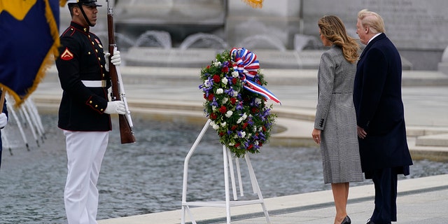 President Donald Trump and first lady Melania Trump participate in a wreath laying ceremony at the World War II Memorial to commemorate the 75th anniversary of Victory in Europe Day, Friday, May 8, 2020, in Washington. (AP Photo/Evan Vucci)