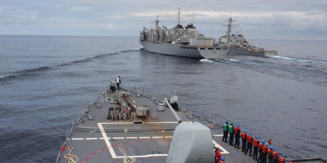 The Arleigh Burke-class guided-missile destroyer USS Donald Cook makes her approach alongside USNS SUPPLY and USS Porter for a connected replenishment to receive fuel and stores on April 28. (Photo by Yeoman Third Class Anthony Nichols)