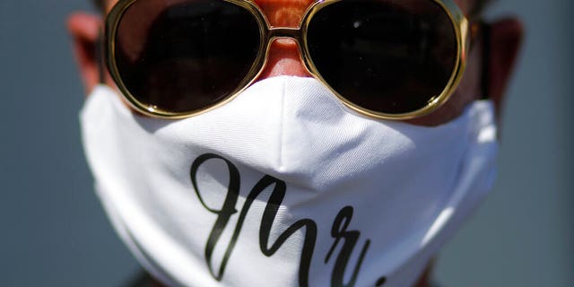Vaughan Chambers wears a mask after marrying Alicia Funk at A Little Wedding Chapel, Tuesday, May 12, 2020, in Las Vegas. (AP Photo/John Locher)