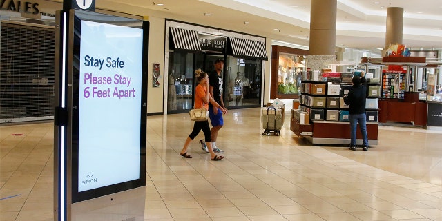 Signage encourages social distancing as Penn Square Mall reopens to the public Friday, May 1, 2020, in Oklahoma City. The mall has been closed since mid-March due to coronavirus concerns. 