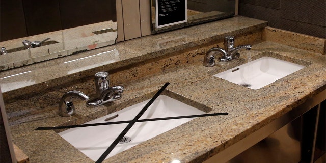 Alternating sinks in the restroom at Penn Square mall are taped off to promote social distancing as the mall reopens Friday, May 1, 2020, in Oklahoma City. The mall has closed one of two restrooms and five of seven entrances. The mall has been closed since mid-March due to coronavirus concerns.