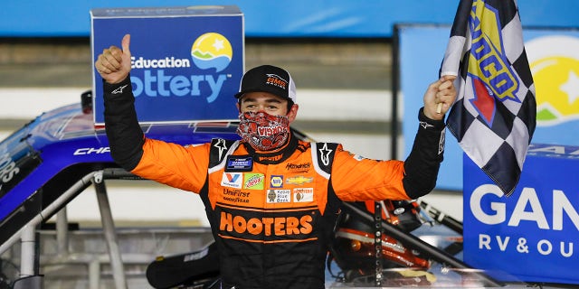 Chase Elliott celebrates after winning the NASCAR Truck Series auto race at Charlotte Motor Speedway Tuesday, May 26, 2020, in Concord, N.C. (AP Photo/Gerry Broome)