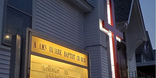 The Adams Square Baptist Church in Worcester, Mass., has a sign that says, "Church is essential," as state city officials issue fines and threat of jail time to the pastor.