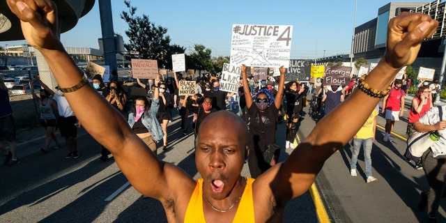 Demonstrators protest for George Floyd in downtown Los Angeles Wednesday, May 27, 2020. (AP Photo/Ringo H.W. Chiu)