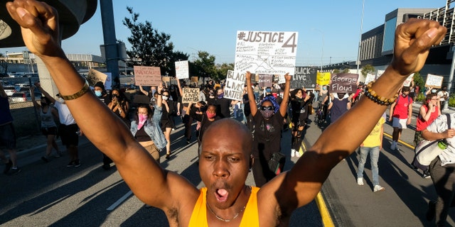Demonstrators protest for George Floyd in downtown Los Angeles Wednesday, May 27, 2020. (AP Photo/Ringo H.W. Chiu)