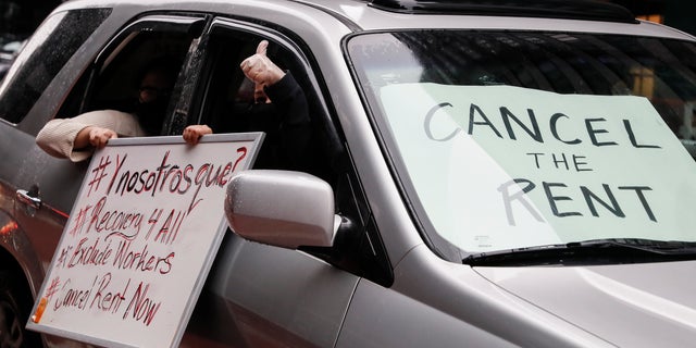 A sign with the message to "CANCEL THE RENT" is displayed in a vehicle windshield as a caravan of May Day protesters drives up 2nd Avenue outside the offices of New York Gov. Andrew Cuomo, on Friday. (AP)