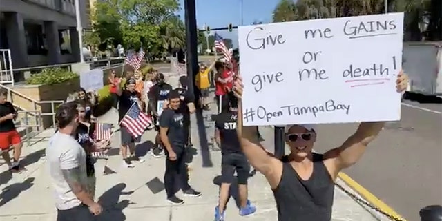 People protest for re-opening the economy at a faster rate outside the Old Pinellas County Courthouse, amid the coronavirus crisis, in Clearwater, Florida, U.S. May 11, 2020 in this still image taken from a social media video. (JOZEF GHERMAN/ FACEBOOK/ OPEN TAMPA BAY/via REUTERS)
