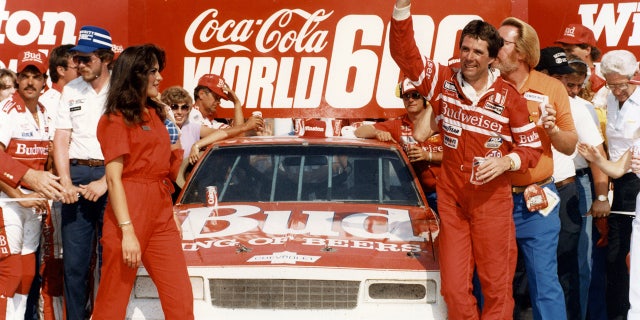 CHARLOTTE, NC — May 26, 1985: Darrell Waltrip waves his cap in victory lane at Charlotte Motor Speedway after winning the Coca-Cola World 600 NASCAR Cup race, one of three Cup victories Waltrip had during the year on his way to a third NASCAR Cup championship. (Photo by ISC Images & Archives via Getty Images)