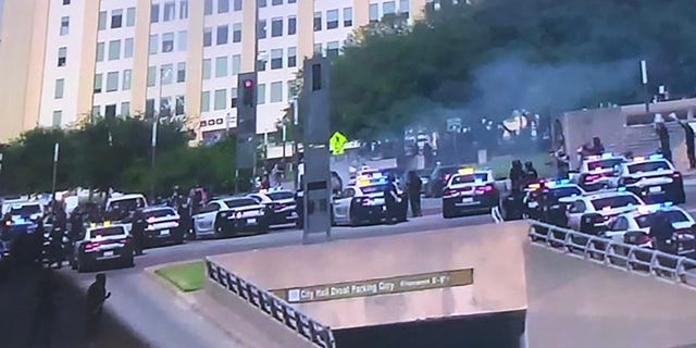 Dallas SWAT deployed gas to disperse the unruly protesters at the corner of Young and Akard Street on Saturday, police said.