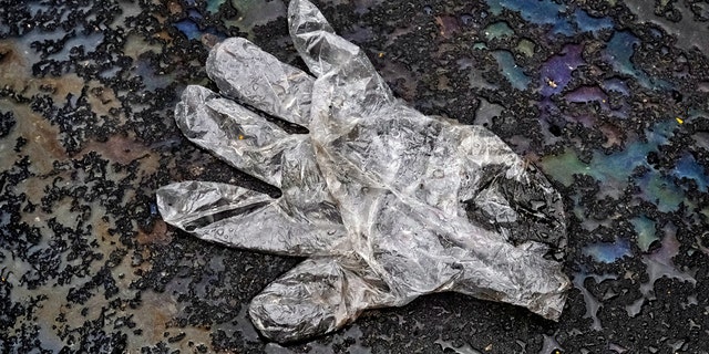 A glove that was tossed to the ground by a delivery person sits in the parking lot of a grocery store in Silver Spring, Maryland on April 30. Officials in Los Angeles are looking to crack down on similar litter in their city. (The Washington Post via Getty Images)