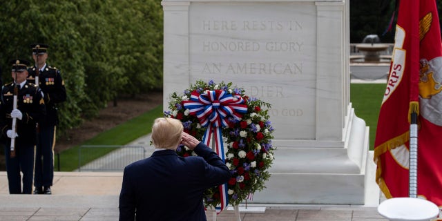 President Donald Trump salutes after placing a wreath at the Tomb of the Unknown Soldier in Arlington National Cemetery, in honor of Memorial Day, Monday, May 25, 2020, in Arlington, Va. (AP Photo/Alex Brandon)