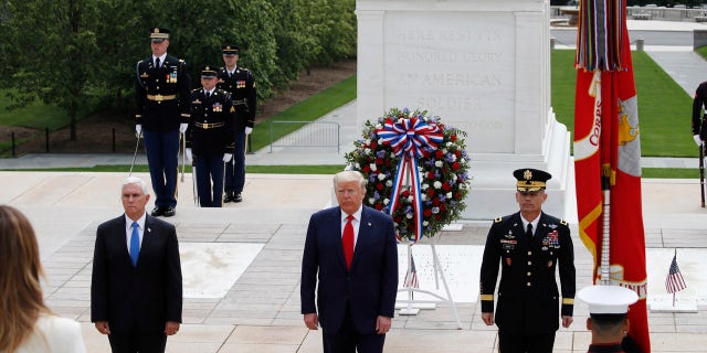 President Donald Trump stands with Vice President Mike Pence and Gen Omar Jones, Commanding General at Joint Force Headquarters, National Capital Region and United States Army Military District of Washington, at the Tomb of the Unknown Soldier in Arlington National Cemetery, in honor of Memorial Day, Monday, May 25, 2020, in Arlington, Va. (AP Photo/Alex Brandon)
